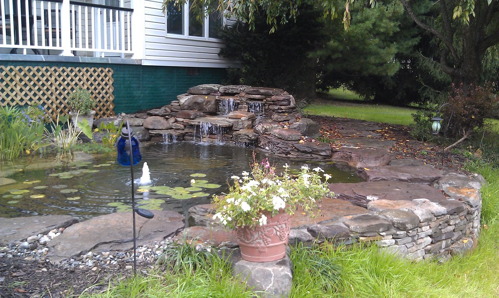 backyard pond by deck with waterfall Pondscapes Maryland