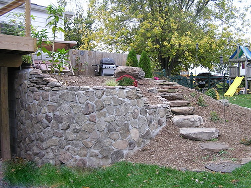 Backyard custom stairs and retaining wall made of stone Pondscapes Maryland