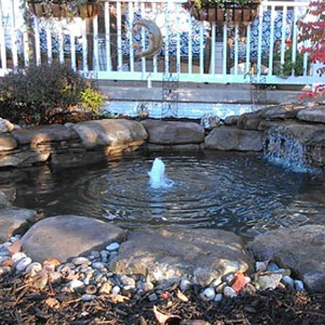Pond installation by a deck with a bubbler Pondscapes Maryland